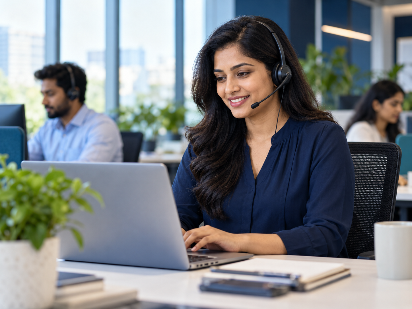 Illustrative photograph of a customer support professional speaking with a customer in a modern office